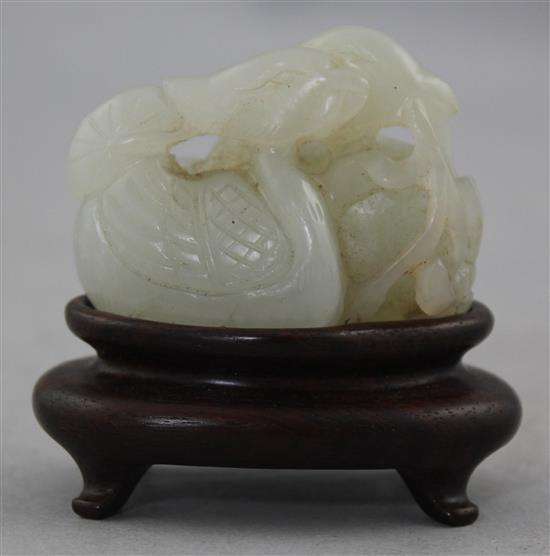 A Chinese white jade carving of two mandarin ducks, 18th / 19th century, 4.8cm., wood stand